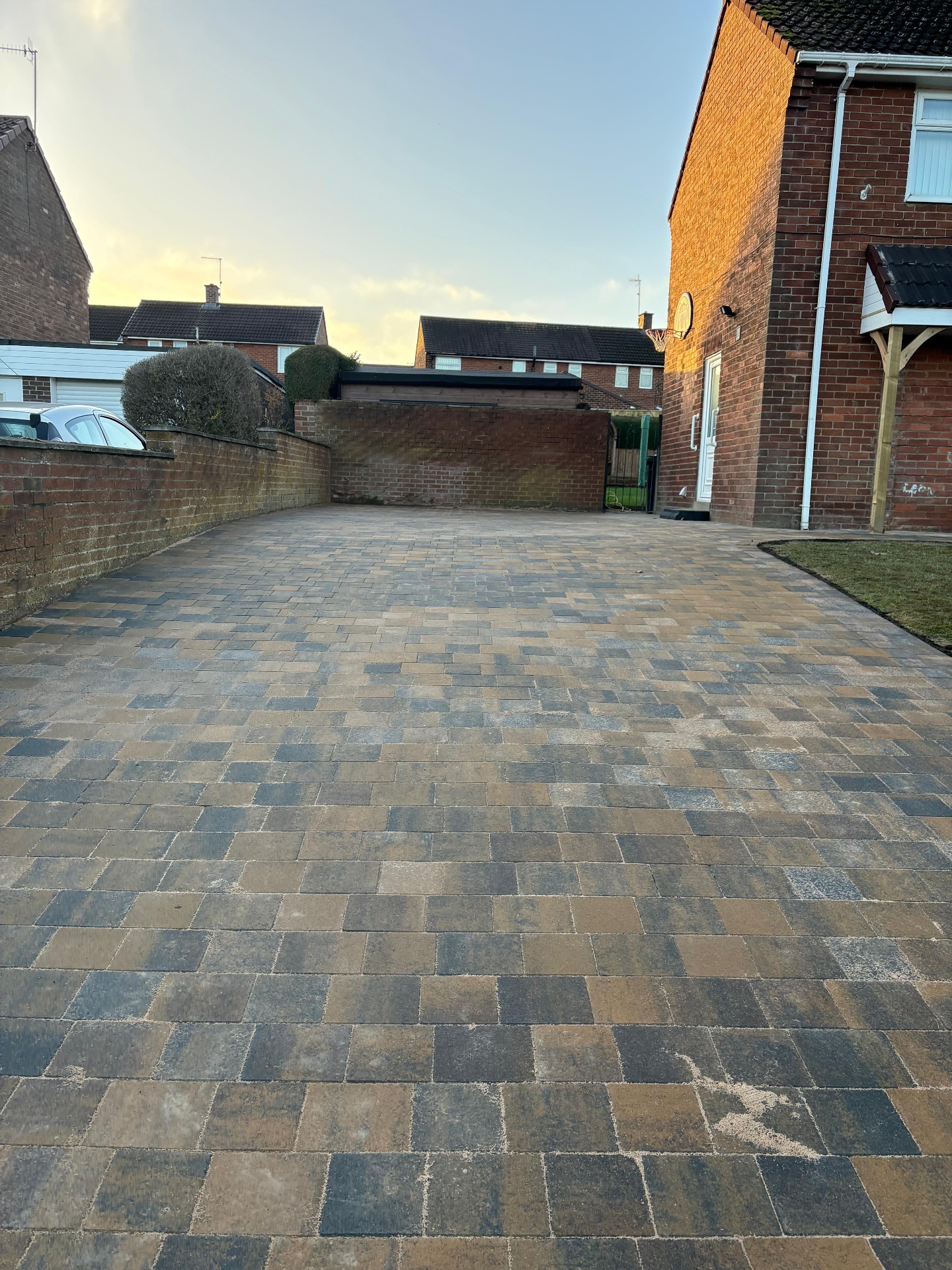 Mixed-tone block paved driveway installed at a brick home