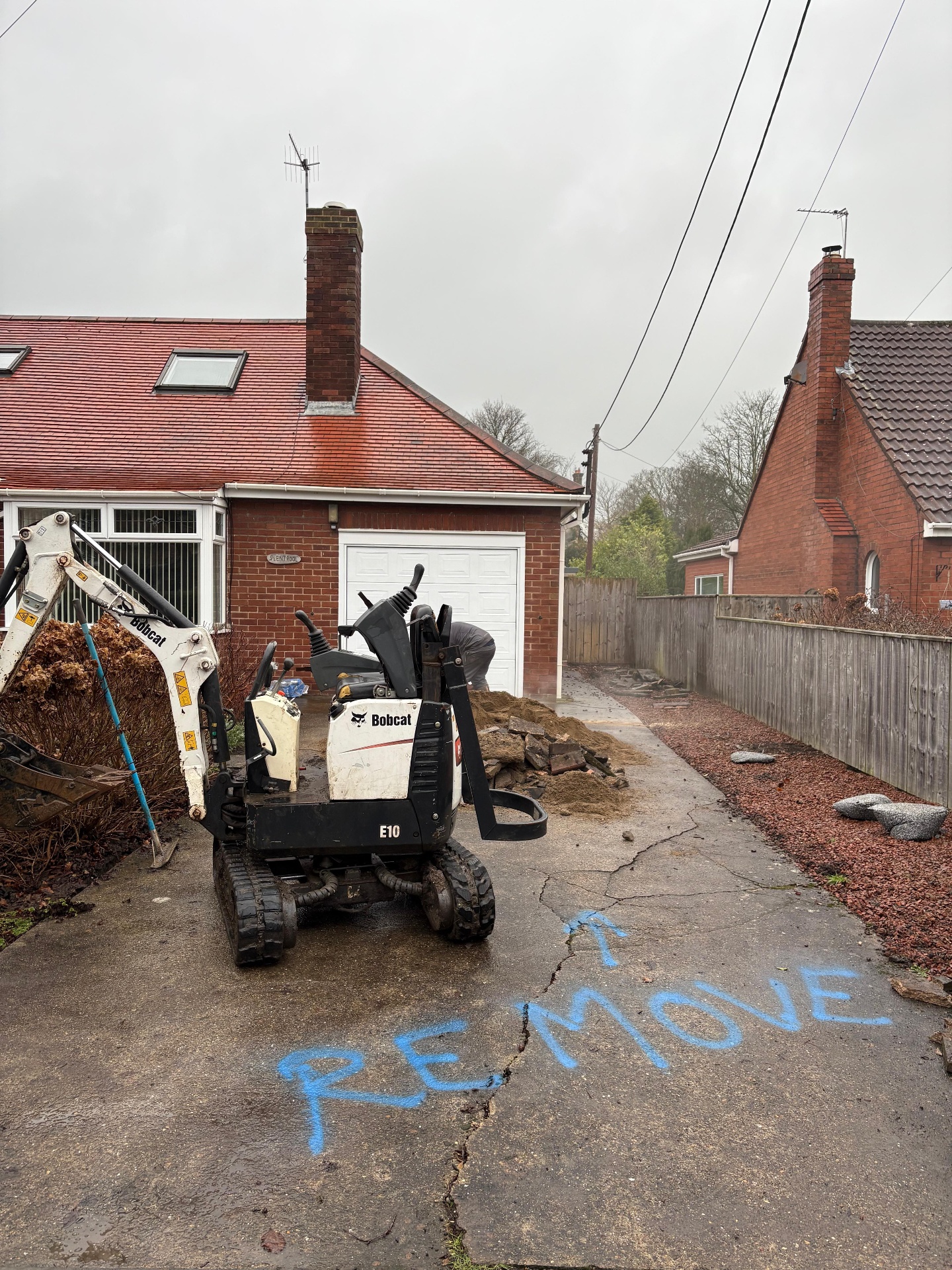 Driveway excavation and base removal work during a full replacement project